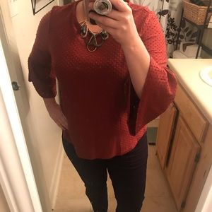 Red Top with 3/4 length bell sleeve.